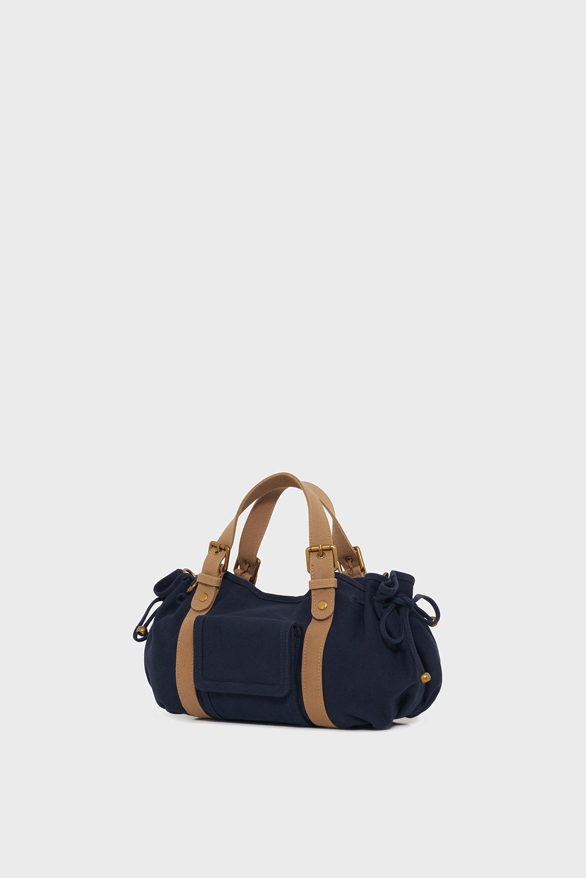 A navy blue GD Canvas sac à main with tan leather handles and straps, featuring side ties and a small front pocket, displayed on a plain light background.