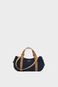 A navy blue GD Canvas duffel bag with tan handles and straps is centered on a plain light gray background. The sac à main features small metal accents and gathered sides.