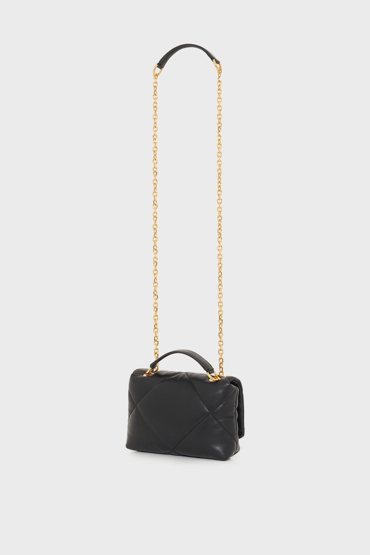 A small black sac créateur, this quilted leather handbag features a gold chain shoulder strap and a short top handle, elegantly displayed on a plain white background.