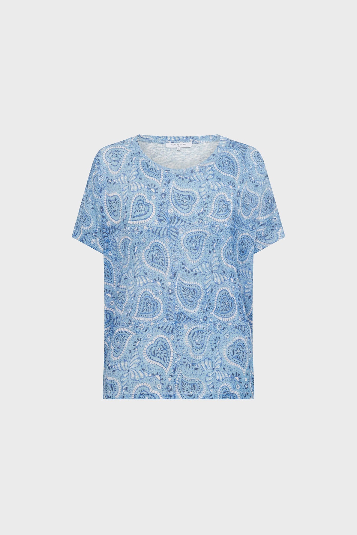 Light blue short-sleeve shirt with a white and blue paisley pattern, displayed on a plain white background. The shirt has a relaxed fit and a round neckline.