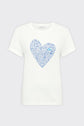 White short-sleeve t-shirt featuring a large heart shape on the front, filled with small blue hearts of varying sizes. The background is plain light gray.