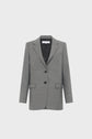 A gray blazer femme tailored with two buttons, a notched lapel, and three front pockets, displayed on a plain white background.