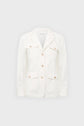 White blazer-style jacket with four front pockets and light brown buttons, displayed against a plain light grey background.