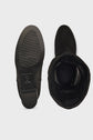 A pair of black suede boots, one shown from the sole and the other from the top, displaying the interior and the tread pattern of the sole.