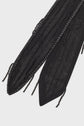 Close-up of a black voile noir foulard or sash featuring textured beaded embellishments, sparkling sequins, and dangling bead strands, displayed on a light background.