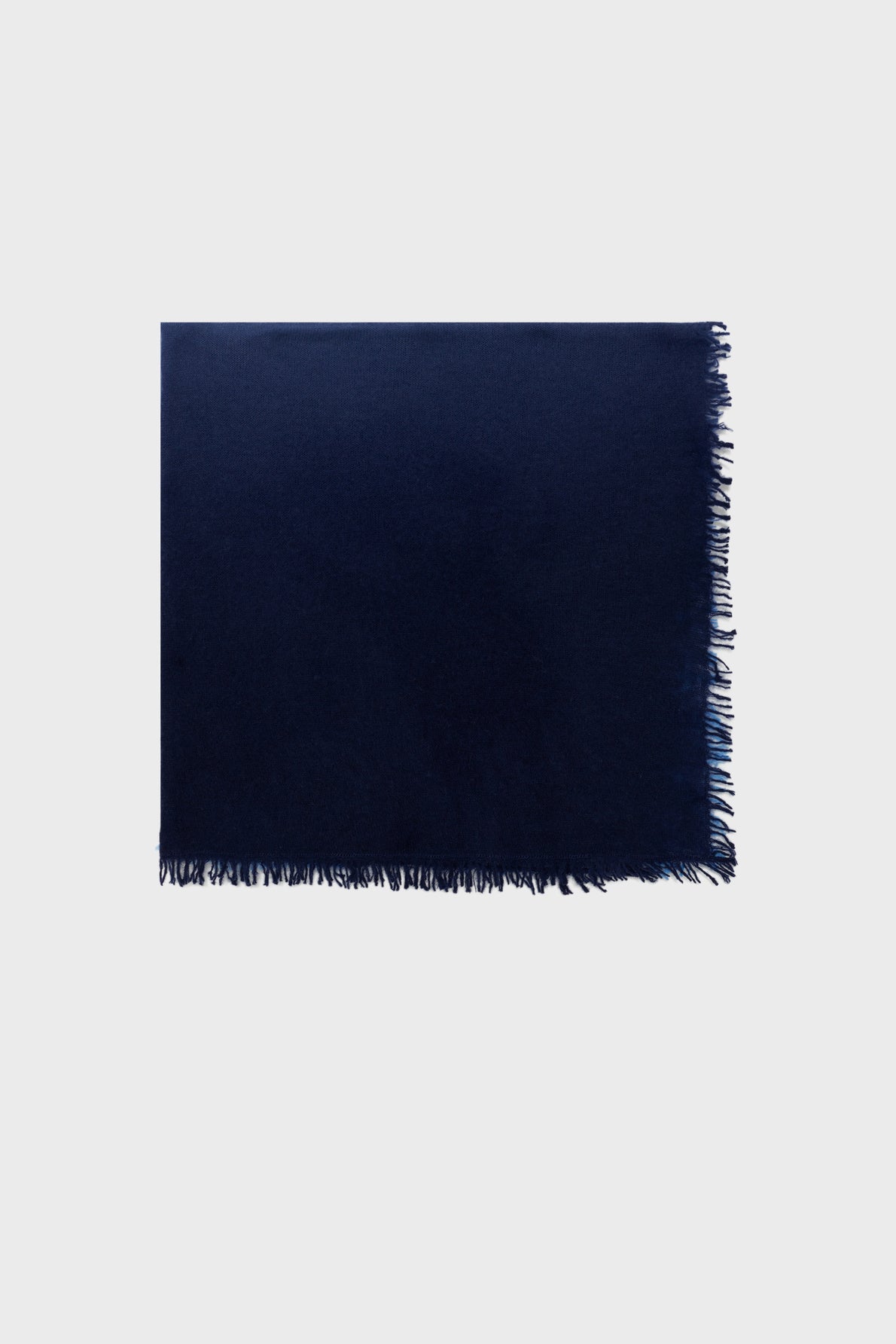 A dark blue rectangular scarf, or écharpe bleu, with short fringe along one edge, displayed flat against a plain light gray background.