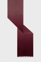 A long, rectangular echarpe bordeaux in a gradient burgundy color is shown, folded at an angle, with short fringes at one end, against a light gray background.