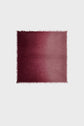 A rectangular maroon rug with a subtle gradient from dark to light and short fringe along the edges, reminiscent of the elegant tones found in an echarpe bordeaux or echarpe cachemire, displayed on a plain white background.