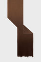 A long, brown wool scarf with a slight gradient and fringed ends, this élégante écharpe marron is displayed on a light gray background.