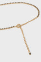Gold-tone ceinture chaîne belt adorned with black gemstones and strass gris bleuté, featuring a circular logo clasp and a dangling chain ending in a single gemstone.