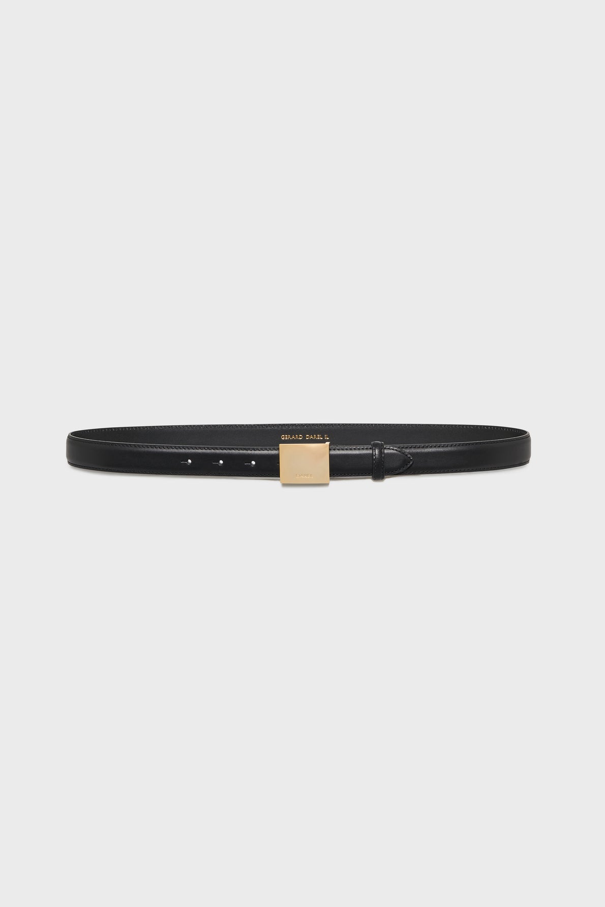 A thin black ceinture en cuir with a rectangular gold buckle, displayed on a plain white background, this ceinture élégante adds a refined touch to any outfit.
