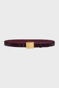 A sleek burgundy ceinture cuir with a rectangular gold buckle, displayed on a plain white background. This ceinture élégante features subtle engraved text on the buckle, making it the perfect accessoire mode for any refined wardrobe.