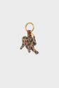 A gold keyring with a toile enduite léopard animal-shaped charm, possibly a calf, attached by a brown leather loop, displayed on a plain white background.
