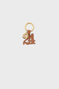 A gold keyring with a brown porte-clé cuir charm shaped like the number 4, featuring white stitching and a small médaille GD attached.