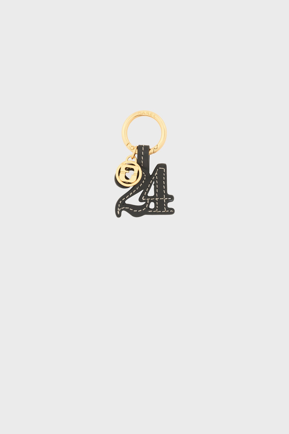 A gold keyring with a black porte-clé cuir number 4 and a small round médaille GD charm featuring an engraved F design, set against a plain light gray background.