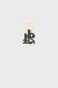 A gold keyring with a black leather charm shaped like the letters A and S outlined in white stitching, inspired by the elegance of a porte-clé cuir, isolated on a light gray background.