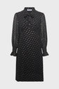 Elegant and timeless, this robe mousseline noire features sheer, long puffed sleeves with ruffled cuffs, a high neckline adorned with a chic col lavallière bow, and a delicate pattern of small white polka dots. The fitted bodice flows into a slightly flared skirt, creating a flattering silhouette for any occasion.
