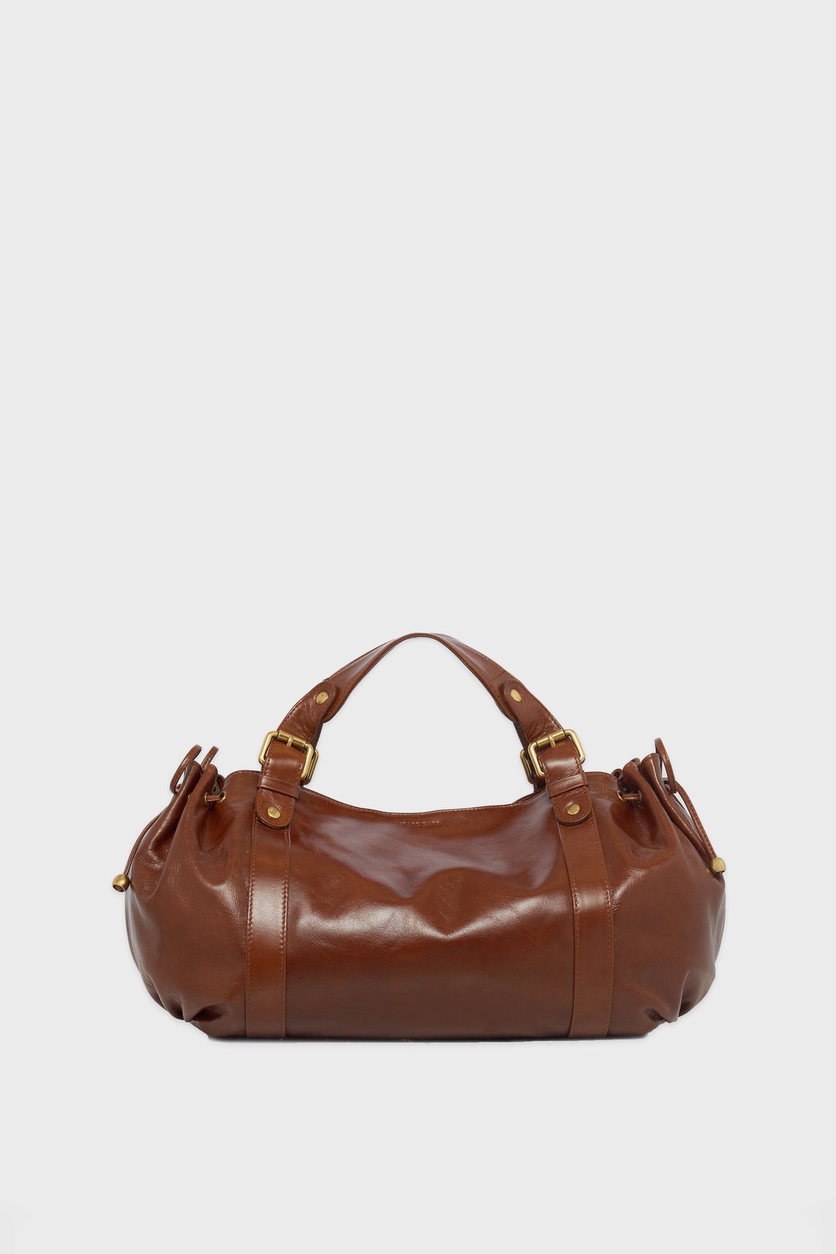 A brown cuir froissé leather sac à main with gold hardware, double handles, and side straps, resting against a plain white background.