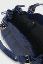 A close-up of an open navy blue sac à main cuir Vanessa Bruno with gold hardware, showing the spacious black interior and drawstring closure, perfect for use as a chic sac 24H.