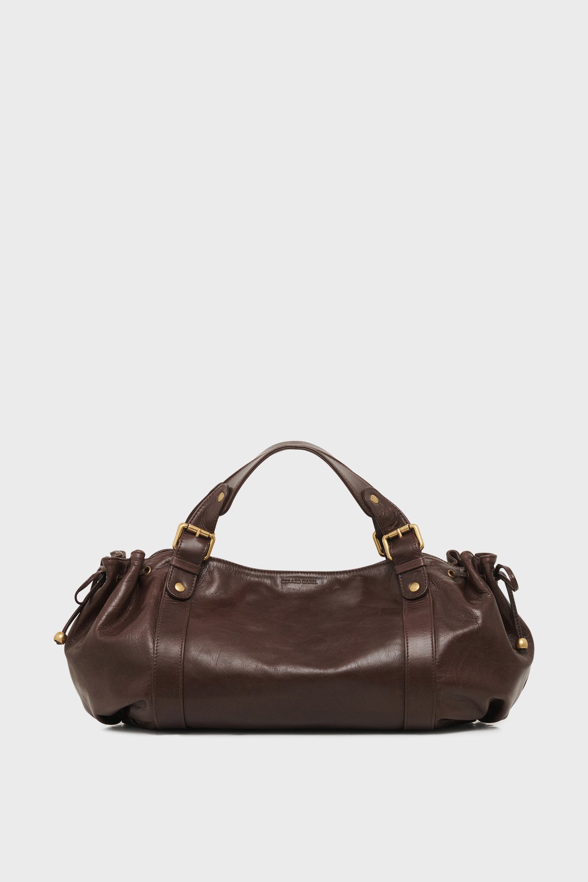 A dark brown sac à main crafted from cuir de vachette froissé, featuring gold hardware, two handles, and side drawstring details, displayed on a plain white background.
