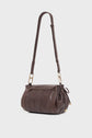 A dark brown besace cuir shoulder bag with gold hardware, an adjustable strap, a flap closure, and side drawstring details, shown on a plain white background.