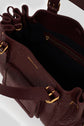 Top view of an open burgundy leather sac à main with gold hardware, featuring a zippered inner pocket, organized interior sections, and embossed Gerard Darel branding in cuir bubble.