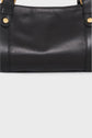 A close-up of a black leather sac à main with gold button details and subtle embossed branding near the top center. The design features a plain light gray background and includes a bandoulière amovible for versatile carrying options.