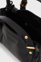 Close-up of an open black leather sac à main with gold hardware and visible compartments, featuring the Gerard Darel brand embossed on the front and a practical bandoulière amovible for versatile carrying options.