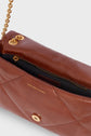 Brown quilted leather handbag in cuir with gold chain strap and hardware, shown partially open to reveal a zippered inner compartment and Gerard Darel logo inside—a chic sac bandoulière from the renowned créateur.