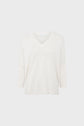 A plain, off-white, V-neck sweater with three-quarter length sleeves is displayed against a light gray background.