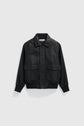 Black leather bomber jacket with a front zipper, two large front flap pockets, a pointed collar, and ribbed cuffs and hem, crafted from luxurious cuir d’agneau and displayed on a plain light gray background.