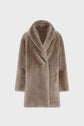 A taupe faux fur coat with long sleeves, a wide shawl collar reminiscent of a classic manteau col châle, and a straight cut, displayed against a plain white background.