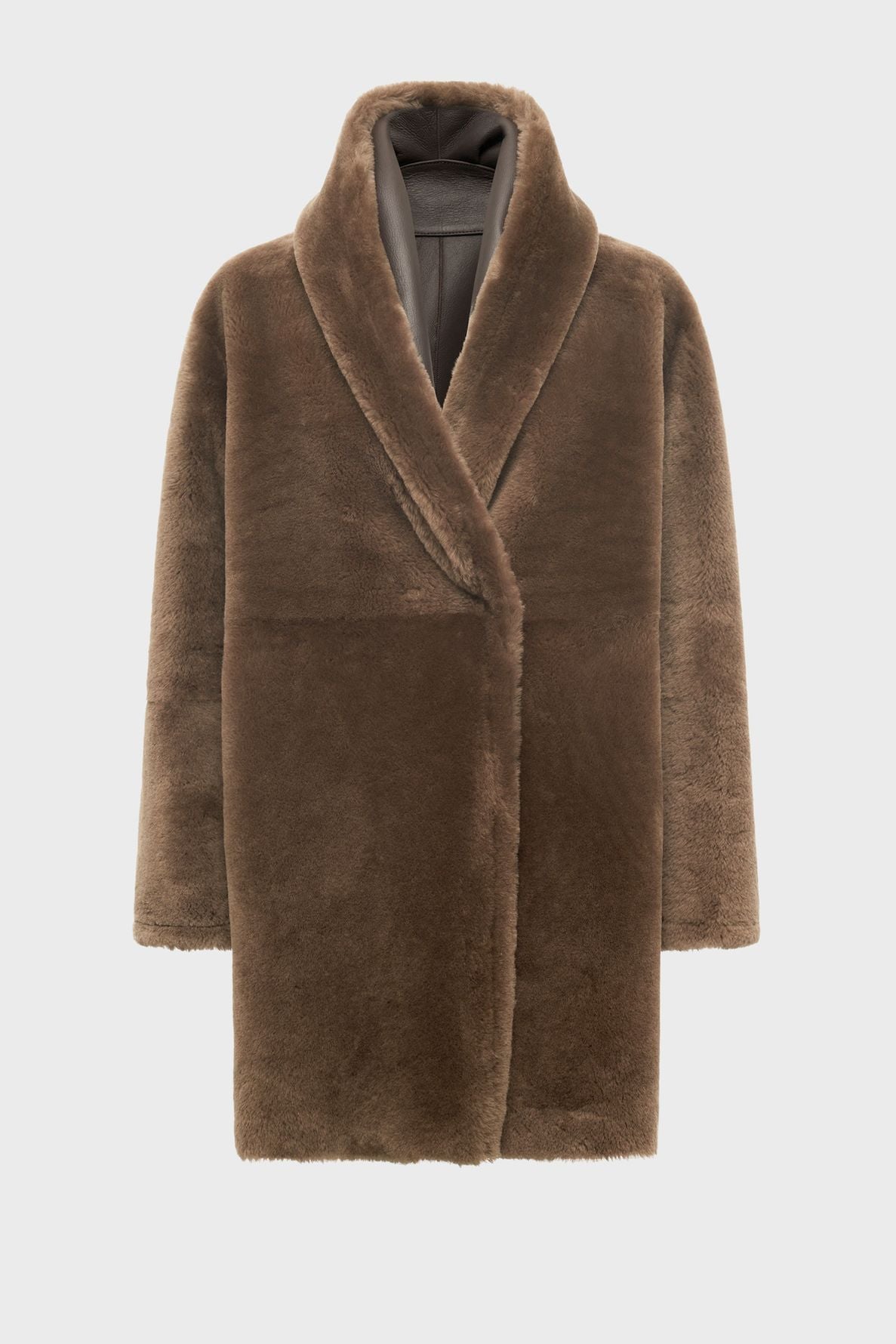 Brown faux fur coat with a shawl collar and long sleeves, displayed against a plain white background. Reminiscent of a manteau peau lainée, the coat appears plush and warm, with a slightly oversized fit and a hidden closure.