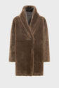 Brown faux fur coat with a shawl collar and long sleeves, displayed against a plain white background. Reminiscent of a manteau peau lainée, the coat appears plush and warm, with a slightly oversized fit and a hidden closure.