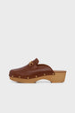 Brown leather clog with a wooden sole (talon bois), gold buckle detail on top, and small gold studs along the base, displayed on a white background—an elegant pair of sabots cognac perfect for elevating any outfit.
