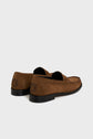 A pair of brown suede loafers with black rubber soles, viewed from the back and side, featuring a stitched design on the heel—these mocassins cuir velours are perfect for those seeking chaussures casual chic.