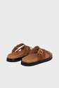 Brown suede sandals with wide crisscross straps, gold buckle detail, tan footbeds, and black rubber soles, displayed on a light background—these sandales plates en cuir velours offer effortless style and comfort for everyday wear.