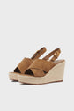 Brown suede wedge sandals with crisscross straps, ankle buckle closure, and espadrille-style woven platform soles, shown on a plain white background.