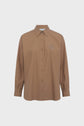 A long-sleeved, brown button-up shirt with a collar and an embroidered logo on the left chest, crafted from soft chemise coton popeline camel, displayed against a plain white background.