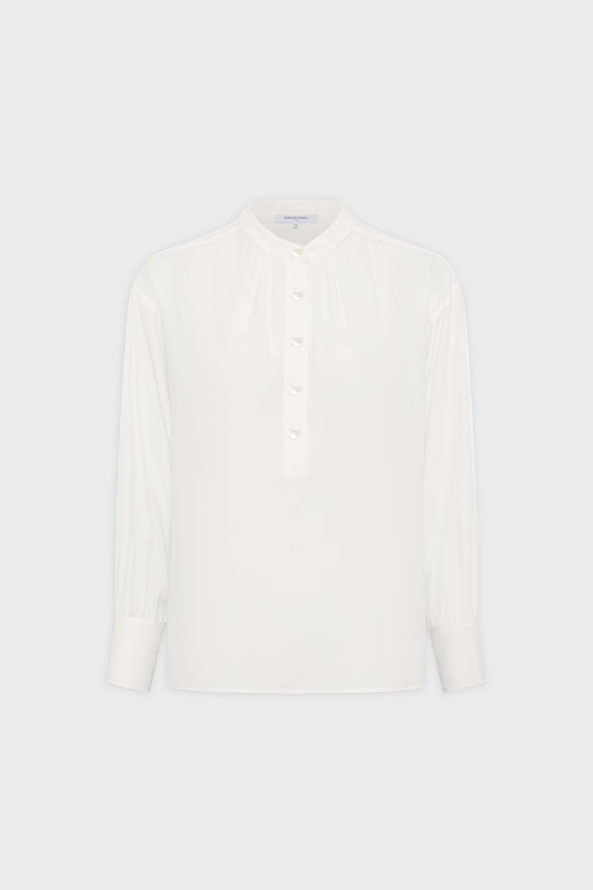 A white long-sleeve blouse with a round neck, partial front button placket, and wide cuffs, displayed on a plain light background.