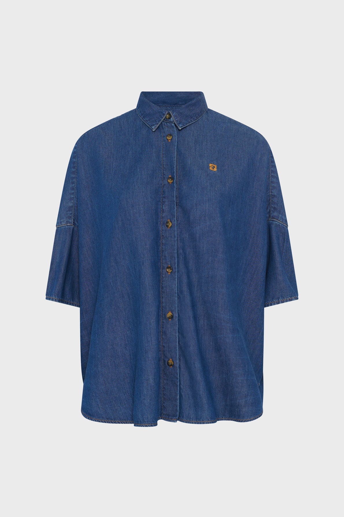 Loose-fitting blue denim shirt with short sleeves, front buttons, and a small yellow embroidered logo on the left chest, displayed on a plain white background.