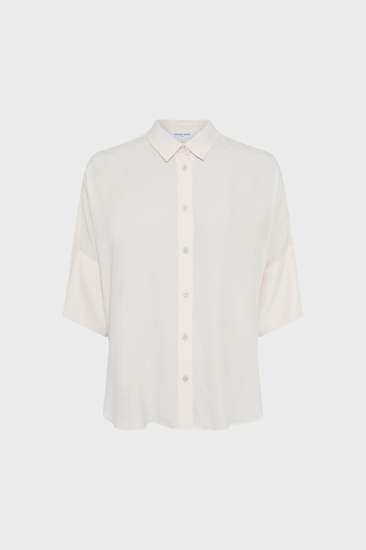 A white, short-sleeve button-up blouse with a collar, loose fit, and straight hem, displayed against a plain light background.