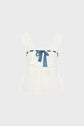 Sleeveless white lace top dentelle with wide straps, a square neckline, and a blue ribbon threaded through the top edge, tied in a bow at the center. Reminiscent of classic esprit lingerie styles, the fabric is slightly sheer and the hem is gently flared.