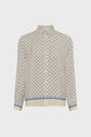 Cream-colored long-sleeve button-up blouse with a blue geometric pattern, a pointed collar, and blue-striped cuffs and hem, displayed on a plain white background—this chemise bleu écru is a chemise fluide élégante that effortlessly combines modern sophistication with timeless style.