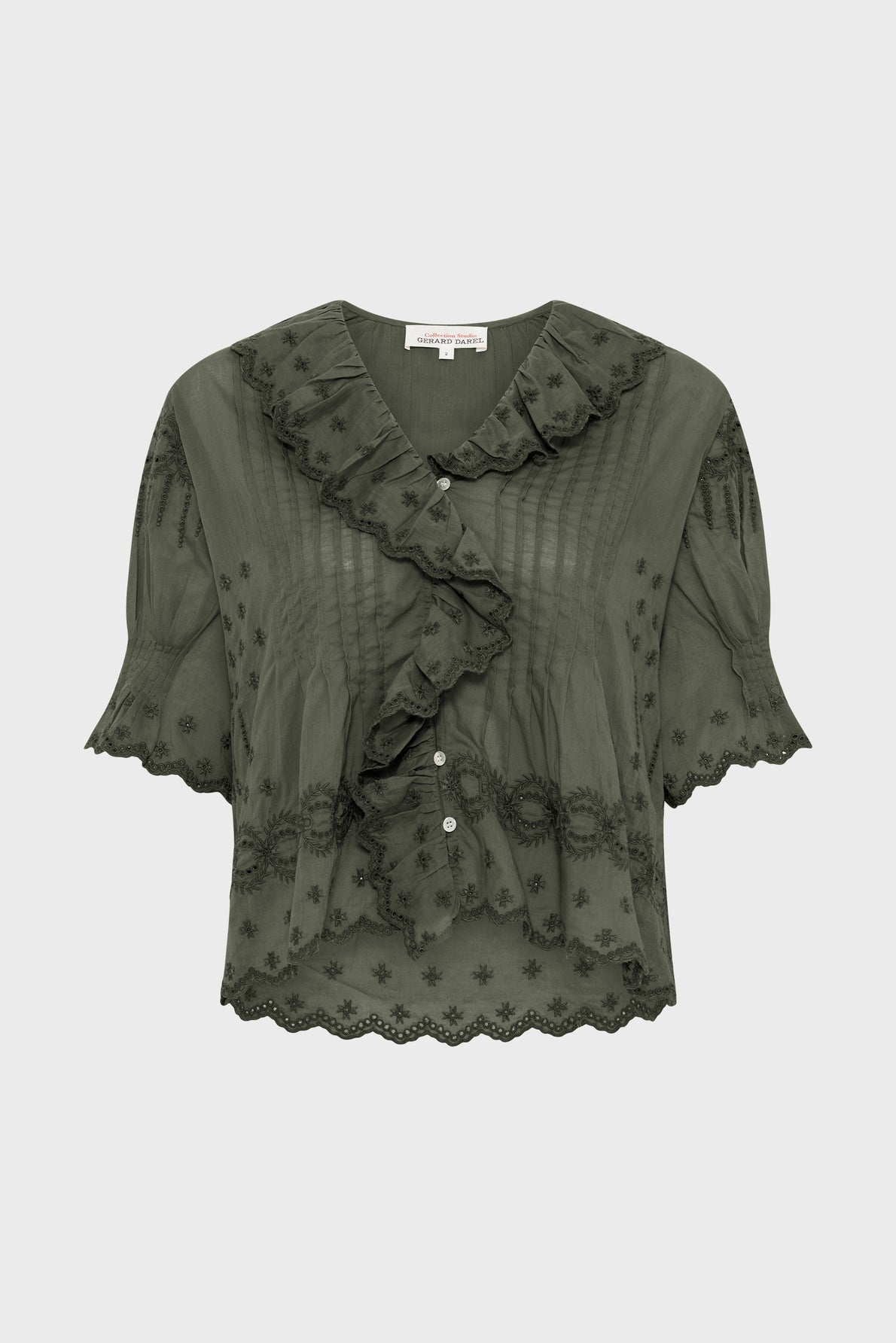 Sheer olive green blouse with ruffled collar, short sleeves, scalloped hem, floral embroidery, pintuck details, and white buttons down the front.