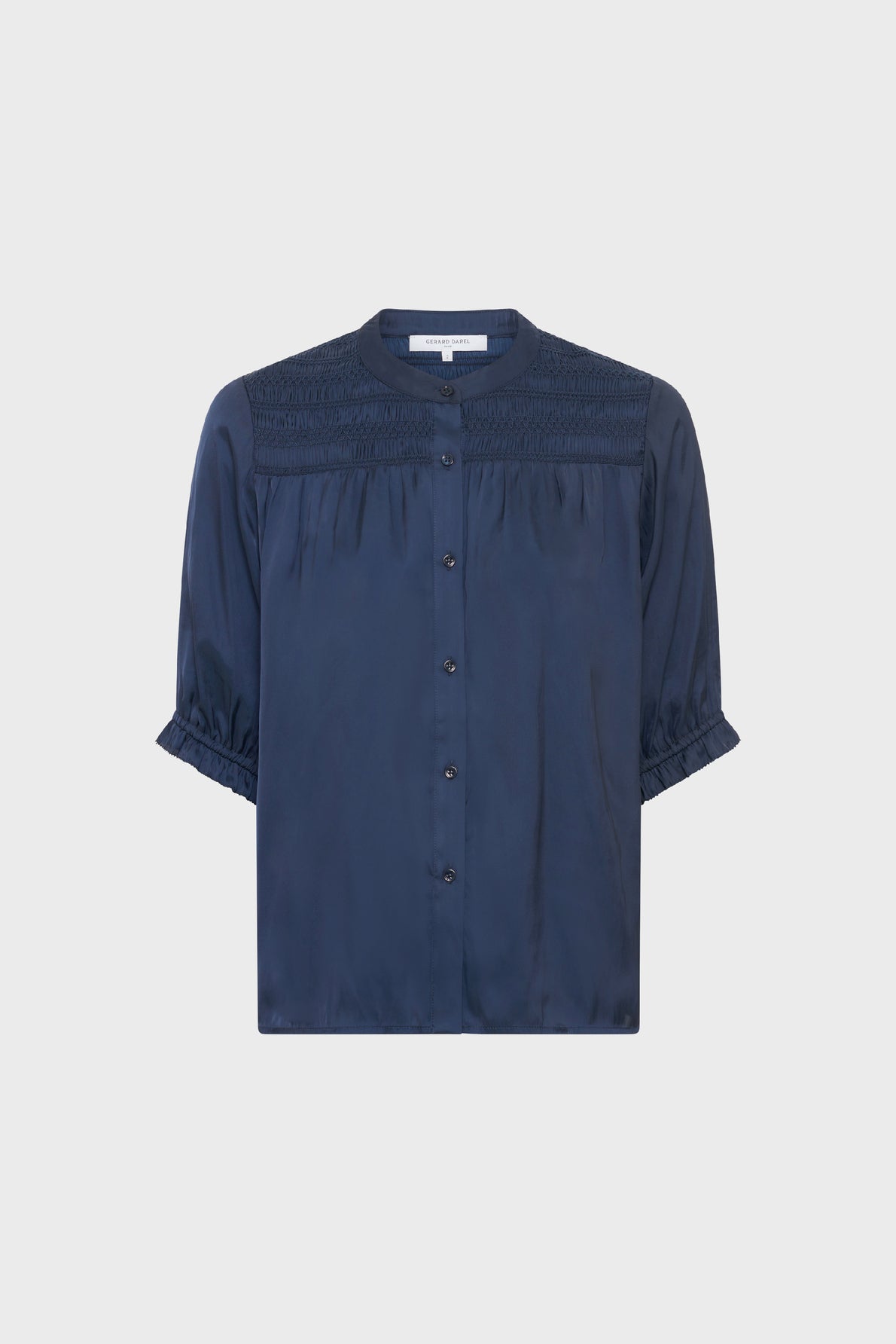 Navy blue, short-sleeved blouse with a round neckline, button-down front, gathered details on the shoulders, and ruffled sleeve cuffs, displayed on a plain white background.