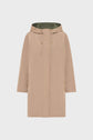 Beige hooded raincoat with a front zipper and drawstring, side pockets, and a green inner lining, displayed on a plain light background. This parka réversible offers versatile style and comfort for your veste mi-saison needs.