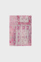 A rectangular, vintage-style rug with faded pink, magenta, and white patterns on a light background, featuring floral and geometric designs reminiscent of a foulard Daisy.