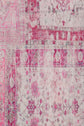 Faded pink and ivory vintage rug with intricate floral and geometric patterns, including borders, diamonds, and small flowers reminiscent of a foulard Daisy motif, giving a distressed, antique appearance.