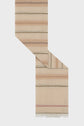 A beige woven textile with horizontal stripes in muted earth tones and small geometric patterns, shown folded with frayed edges at the bottom—perfect as an étole rayée for adding understated bohemian charm to your look.